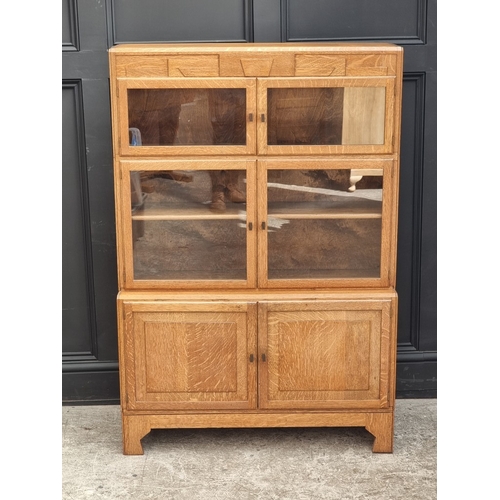 1014 - An Art Deco pale oak sectional bookcase, by Minty, 89cm wide.