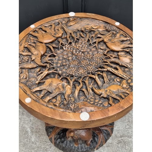 1016 - An Indian carved hardwood pedestal table, 78cm diameter.