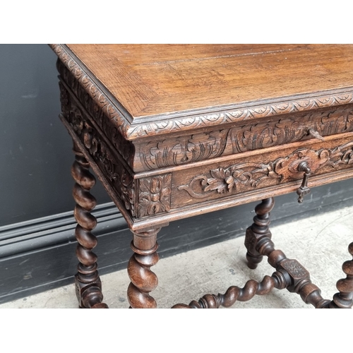 1021 - An early 20th century Continental carved oak occasional table, with hinged top and frieze drawer, 56... 