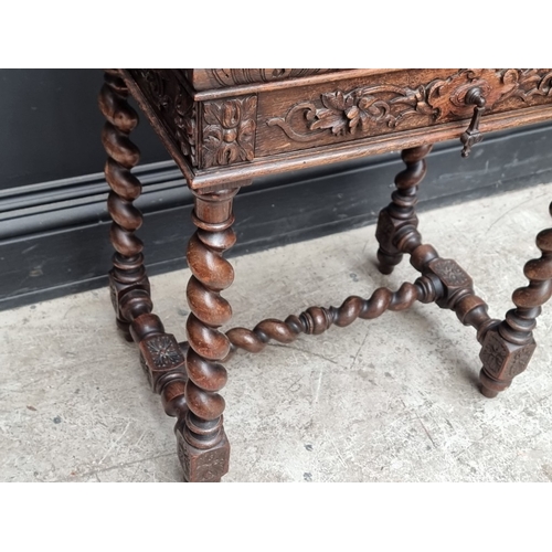 1021 - An early 20th century Continental carved oak occasional table, with hinged top and frieze drawer, 56... 