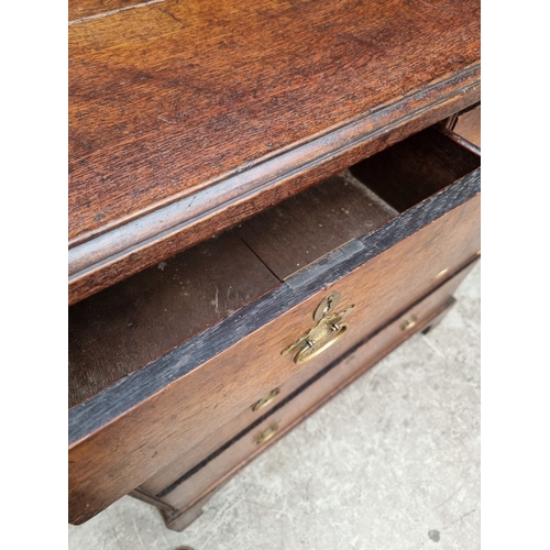 1032 - A George III oak chest of drawers, 95cm wide.