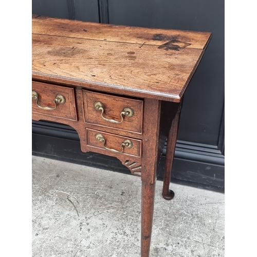 1035 - An 18th century oak and walnut crossbanded lowboy, 83.5cm wide.