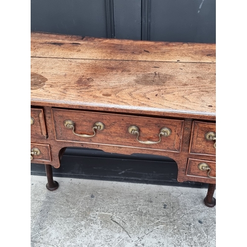 1035 - An 18th century oak and walnut crossbanded lowboy, 83.5cm wide.