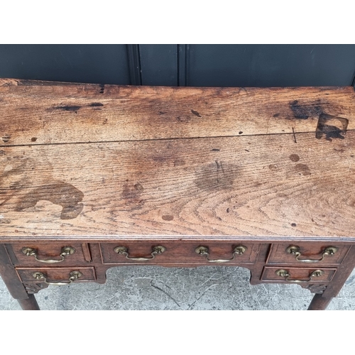 1035 - An 18th century oak and walnut crossbanded lowboy, 83.5cm wide.