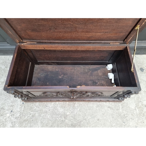 1039 - A late Victorian carved oak 'Green Man' coffer, 99cm wide.