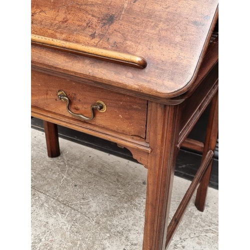 1045 - A George III mahogany architect's desk, with hinged and ratcheted top above a frieze drawer incorpor... 