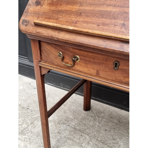 1045 - A George III mahogany architect's desk, with hinged and ratcheted top above a frieze drawer incorpor... 