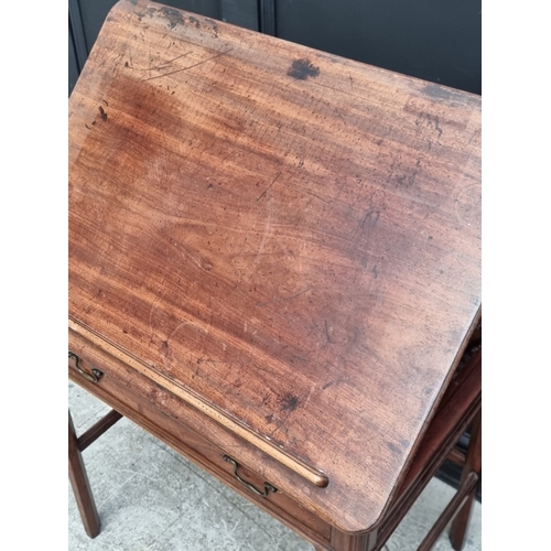 1045 - A George III mahogany architect's desk, with hinged and ratcheted top above a frieze drawer incorpor... 