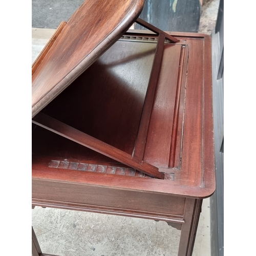 1045 - A George III mahogany architect's desk, with hinged and ratcheted top above a frieze drawer incorpor... 