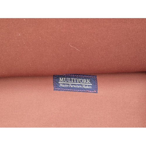 1053 - A red leather settee, from Multiyork, 205cm wide.