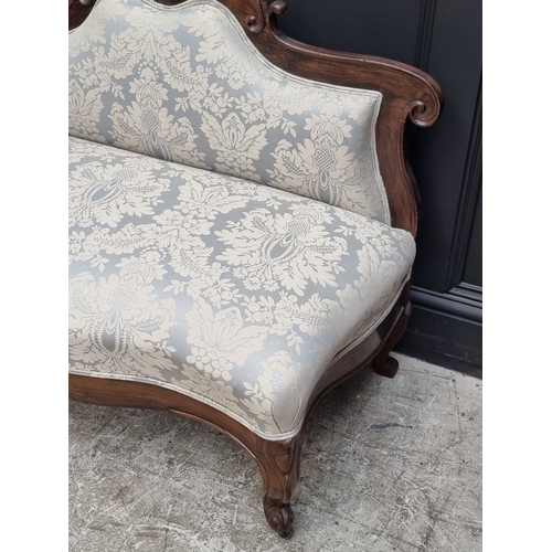 1054 - A small Victorian rosewood and damask upholstered settee, 106.5cm wide.