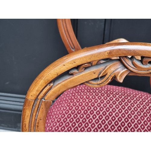 1058 - A set of six Victorian walnut balloon back salon chairs.