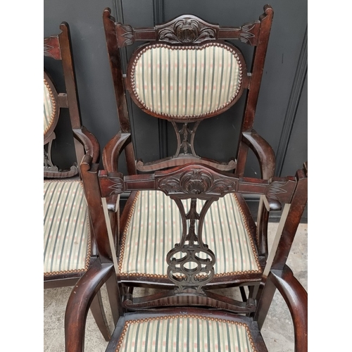 1059 - An Edwardian carved mahogany and upholstered three-piece salon suite, the settee 110.5cm wide.... 