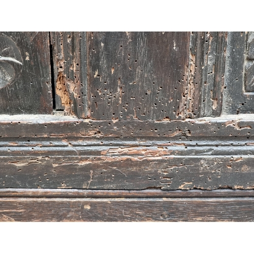 1023 - A late 17th century carved oak panelled coffer, 145cm wide.