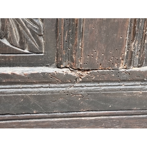 1023 - A late 17th century carved oak panelled coffer, 145cm wide.