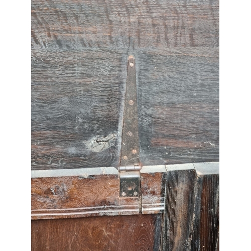 1023 - A late 17th century carved oak panelled coffer, 145cm wide.