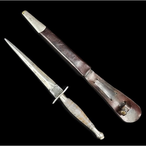 A rare circa 1940 Fairbairn-Sykes 1st pattern commando knife and leather sheath, by Wilkinson Sword, the ricasso etched with maker's mark to one side and 'The F-S Fighting Knife' to the other, with knurled grip, blade 16.5cm, overall 29.2cm.