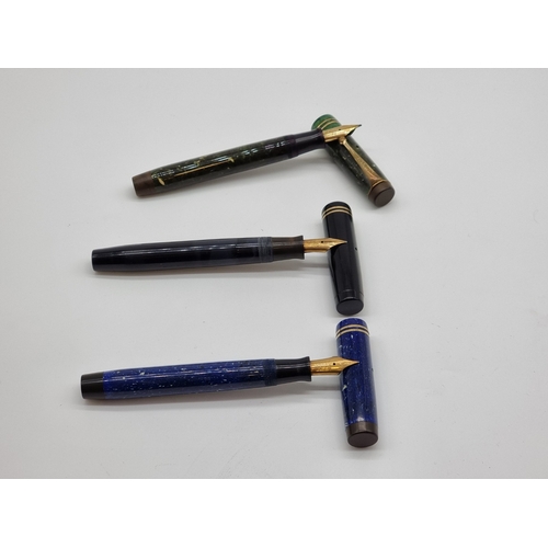Three 1930s Parker Duofold fountain pens, the black example inscribed ...