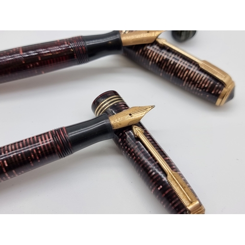 Three 1930s Parker Duofold fountain pens, the black example inscribed ...