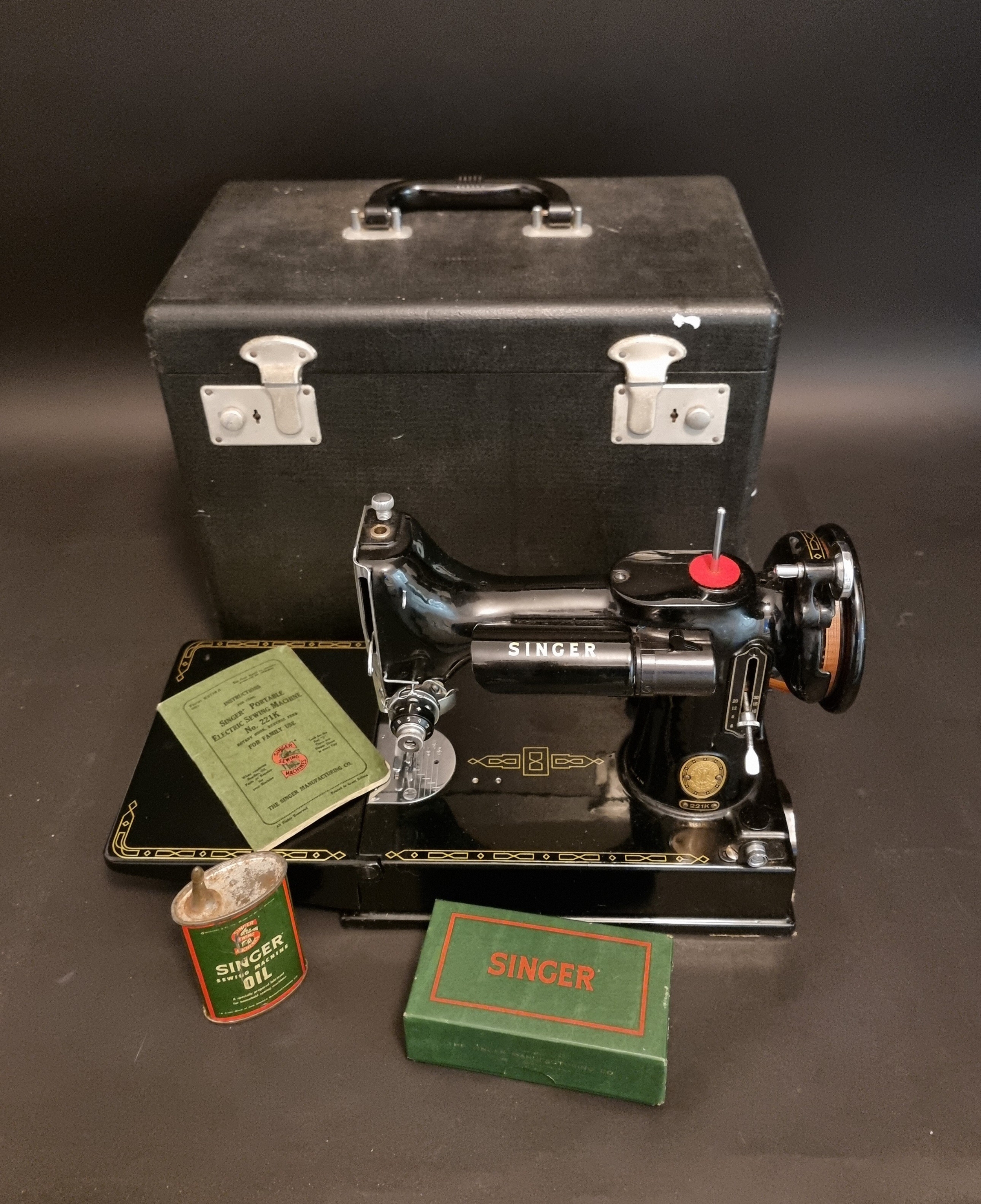 A Singer 221K sewing machine, boxed, with instructions, etc.
