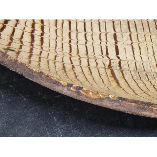 1314 - A good and large antique slipware dish, possibly Isleworth, with combed decoration, 52cm wide.... 