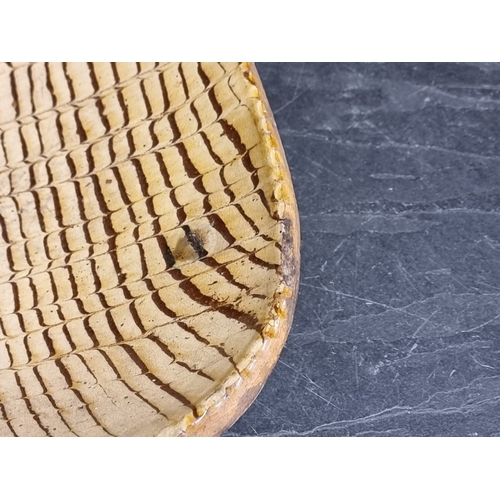 1314 - A good and large antique slipware dish, possibly Isleworth, with combed decoration, 52cm wide.... 