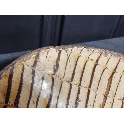 1314 - A good and large antique slipware dish, possibly Isleworth, with combed decoration, 52cm wide.... 