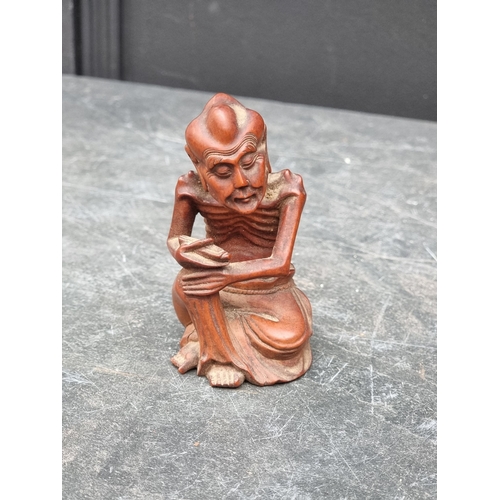 1219 - A mixed lot, to include: a cast iron hound, 21cm long; a Japanese carved wood figure, 10cm high; Chi... 