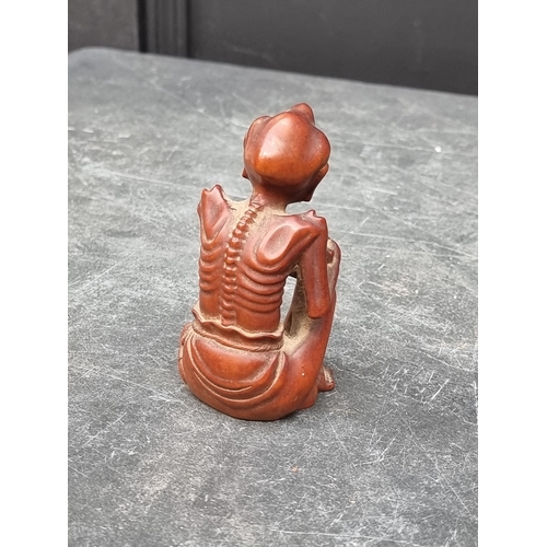 1219 - A mixed lot, to include: a cast iron hound, 21cm long; a Japanese carved wood figure, 10cm high; Chi... 