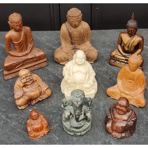 1221 - A collection of carved wood and other Buddhas, largest 17cm high. (9)