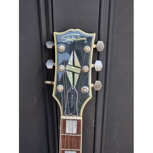 1404 - A circa 1970s Shaftsbury 'Les Paul' style 6-string electric guitar, with associated flight case.... 