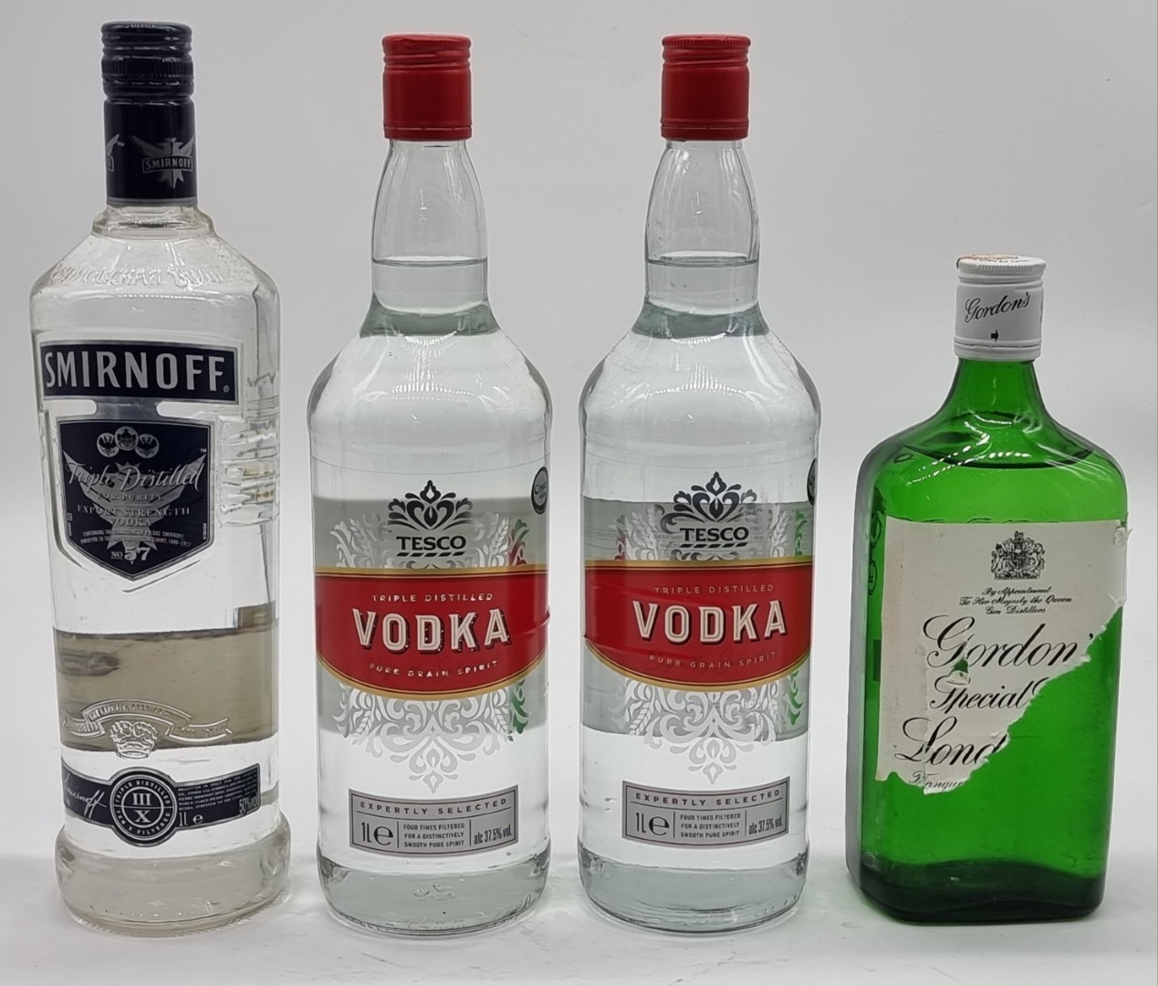 Three 1 litre bottles of Vodka, comprising: Smirnoff No.57; and two ...