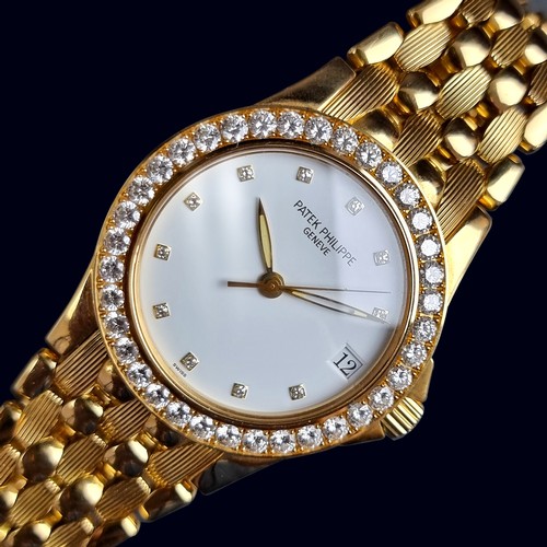 A late 1990s Patek Philippe 'Neptune' 18ct gold automatic wristwatch, 36mm, having diamond set bezel and indices, the 36 diamonds totalling 2.67ct, Ref. 5081/10J-001, Cal. 315 SC, on original 18ct gold 'Nautilus' bracelet, with box and papers, (purchased new from Harrods, Knightsbridge).