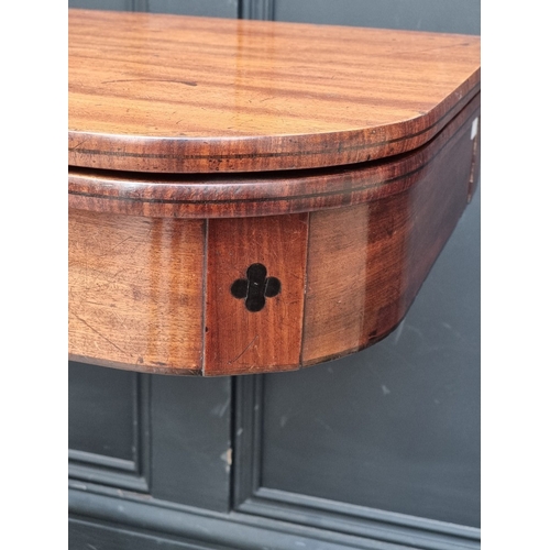1051 - A George IV mahogany and ebony inlaid pedestal tea table, 91cm wide.