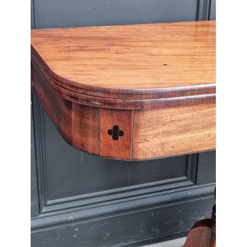 1051 - A George IV mahogany and ebony inlaid pedestal tea table, 91cm wide.