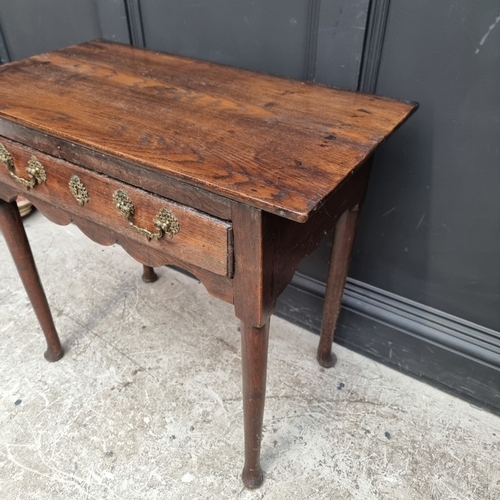 1052 - An 18th century oak single drawer side table, 76cm wide, (alterations).