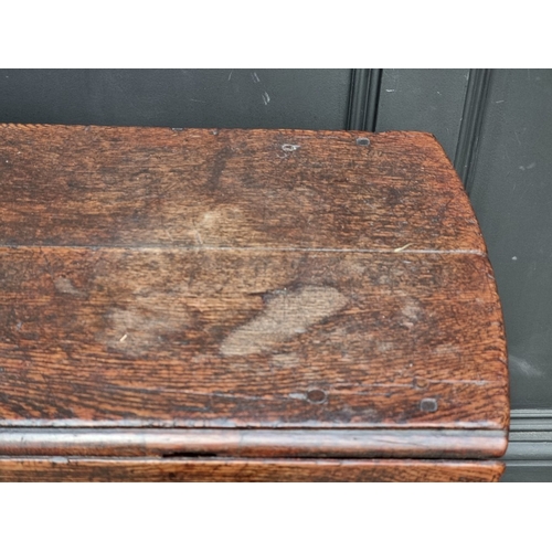 1058 - An early 18th century oak gateleg table, with lateral frieze drawer, 130.5cm wide.