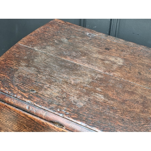 1058 - An early 18th century oak gateleg table, with lateral frieze drawer, 130.5cm wide.