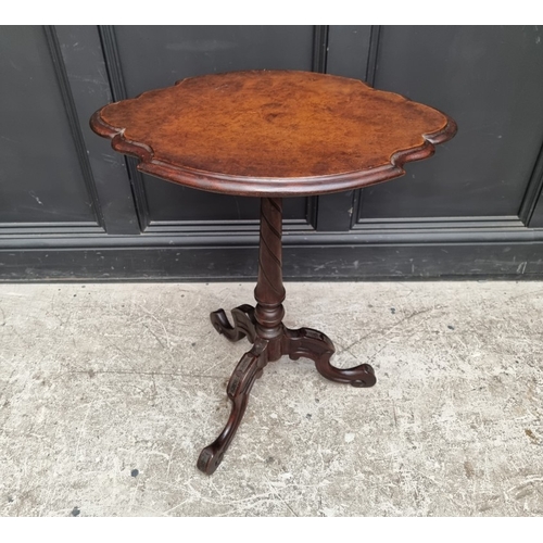 1060 - A 19th century carved walnut tilt-top tripod table, of shaped outline, 58cm wide, (old repair to leg... 