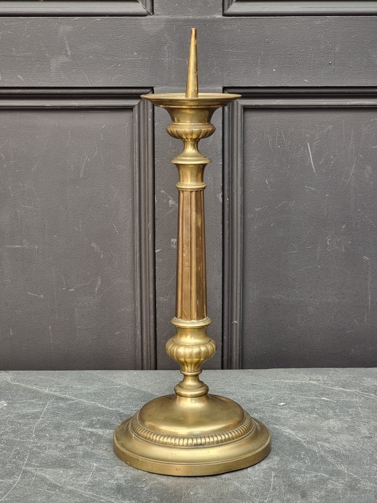 A large brass pricket candlestick, 47cm high.