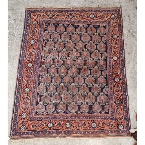 1010 - A Persian rug, having repeated design to central field, with floral and geometric borders, 188 x 142... 