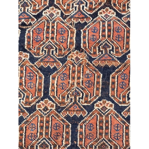 1010 - A Persian rug, having repeated design to central field, with floral and geometric borders, 188 x 142... 
