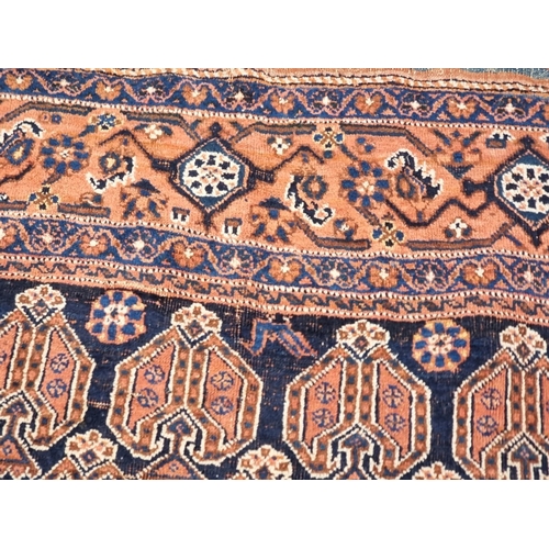 1010 - A Persian rug, having repeated design to central field, with floral and geometric borders, 188 x 142... 