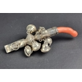 A coral handled silver rattle, marks rubbed, 11.5cm long, (s.d.).