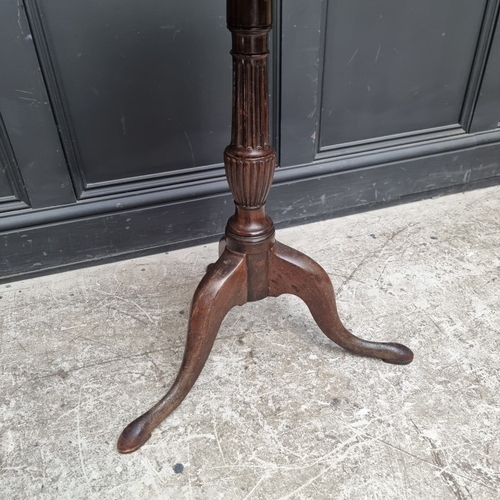 1103 - A George III mahogany tripod table, with dished one-piece tilt-top, 52.5cm wide, (repairs); together... 