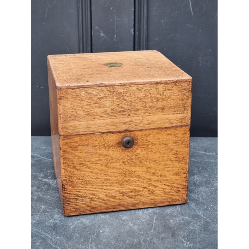 1151 - A Victorian oak decanter box, enclosing four lipped clear glass decanters and stoppers, (one decante... 