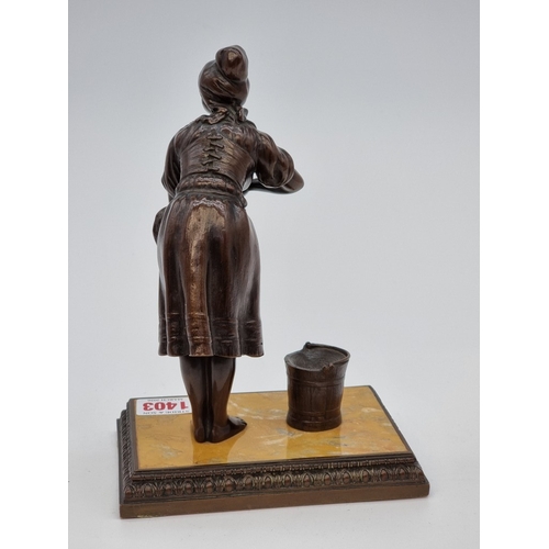 1509 - A bronze washerwoman, with marble inset base, 21cm high.