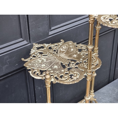 1020 - An unusual antique pierced brass plant stand, with three butterfly tiers, 77cm high.... 