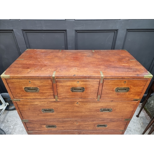 1022 - A late Victorian teak and brass bound campaign chest, in two parts, with countersunk handles, 106.5c... 