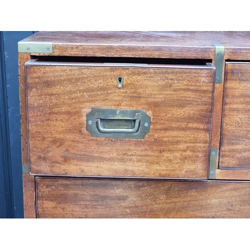 1022 - A late Victorian teak and brass bound campaign chest, in two parts, with countersunk handles, 106.5c... 